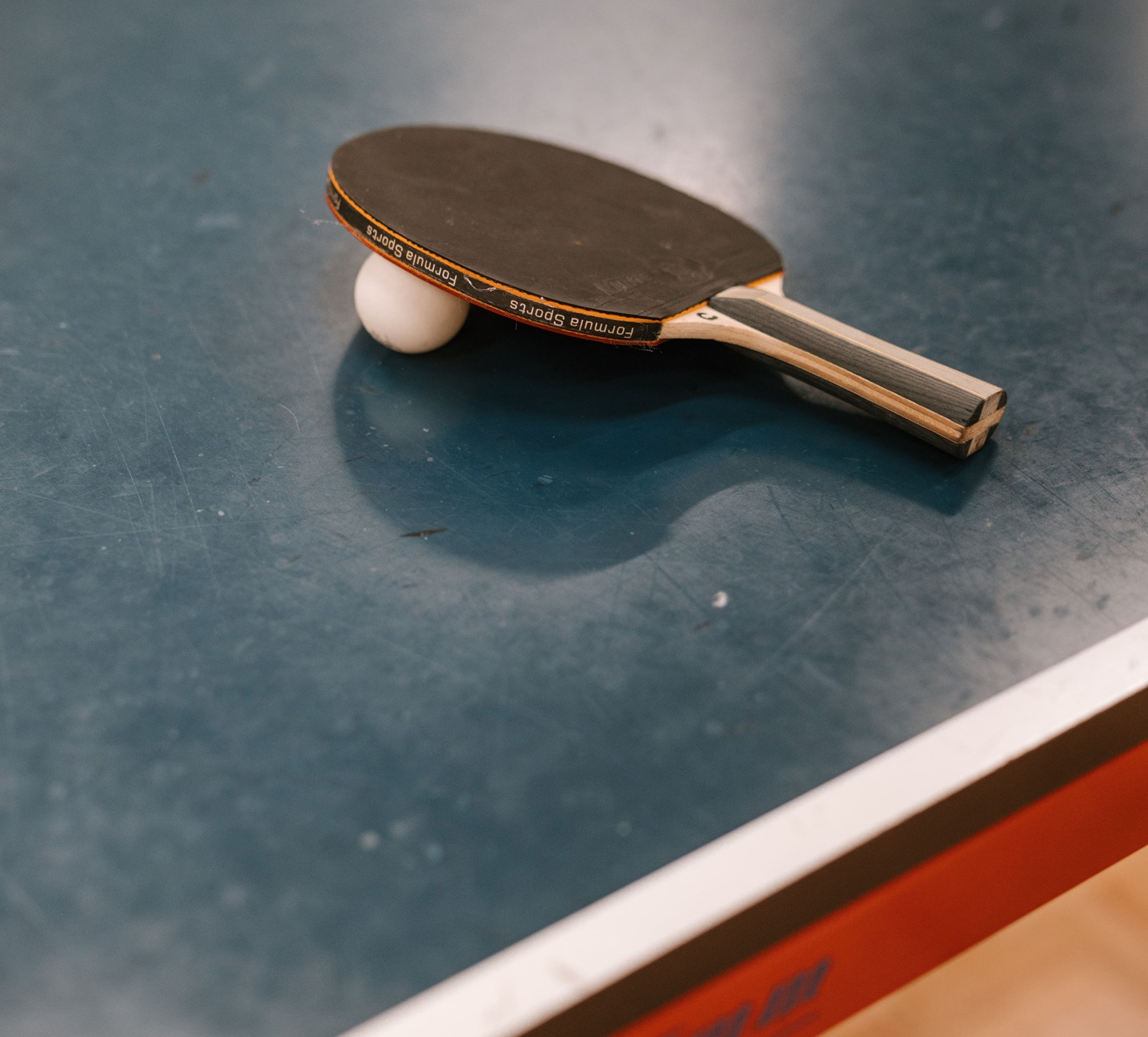 Table Tennis Bat and Ball resting on the table